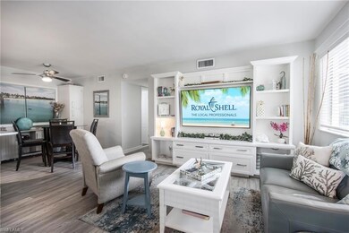 Living room featuring ceiling fan and hardwood / w