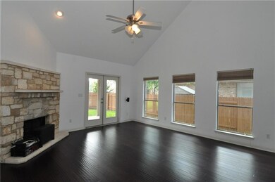 Unfurnished living room with high vaulted ceiling