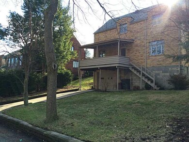 Exterior Back. Notice the yard and the covered bac