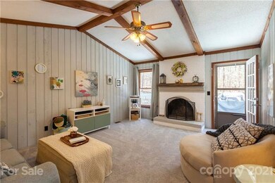 Cozy Den with beams and vaulted ceiling, wood burn