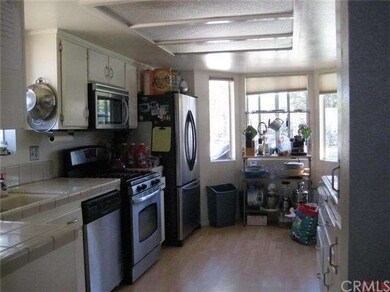 The kitchen has elbow room, with tiled counters an