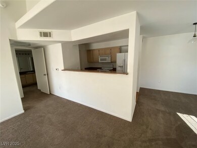 Unfurnished living room with dark colored carpet a