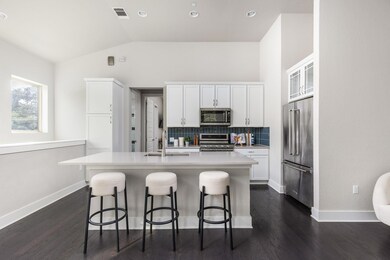 Kitchen featuring a kitchen island with sink, a s
