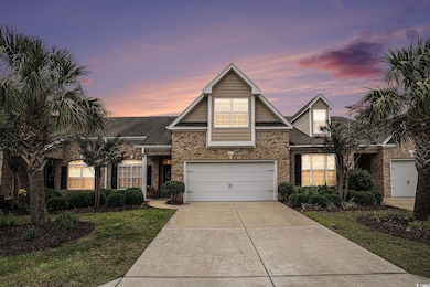 Traditional home with brick siding, driveway, a front yard, and a shingled roof