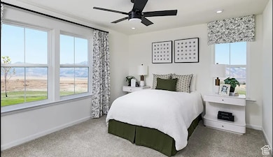 Carpeted bedroom with a ceiling fan and recessed lighting