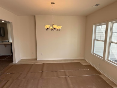 Unfurnished dining area featuring baseboards, wood
