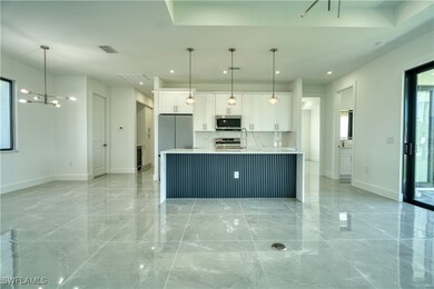 Kitchen featuring white cabinets, appliances with