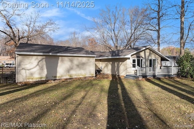 Rear view of property with a yard and a deck