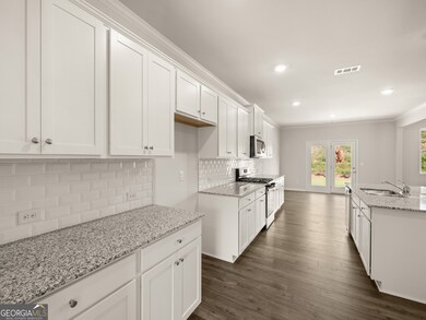 halton kitchen with white shaker cabinets and stainless-steel appliances