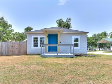 View of front facade featuring a wooden deck and a