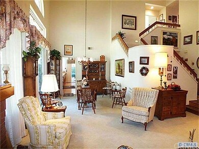 Living room features high ceilings and lots of spa