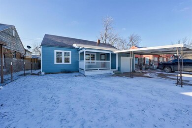 View of front of house featuring fence, a chimney,
