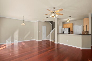 Unfurnished living room with ceiling fan, dark wo