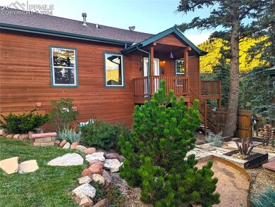 Rear view of property featuring a wooden deck