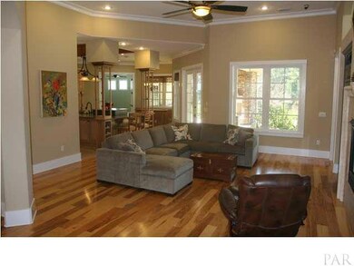View of the great room from the foyer. Master suite entrance to the right of the double windows.