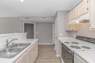 Kitchen featuring white range with electric cookto