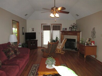 Large great room has hardwood flooring and coffere
