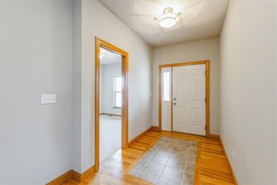 Foyer - wood flooring flows thru to living, dining