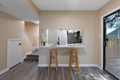 Kitchen featuring dark wood-style floors, a break