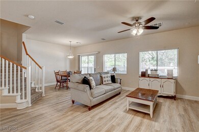 Living area with light wood finished floors, stair