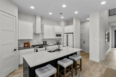 Kitchen with wall chimney exhaust hood, stainless
