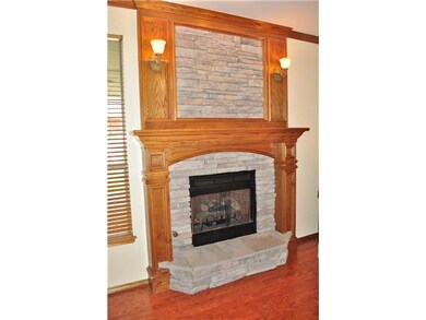 Living Room. Rich stack stone fireplace with sconc