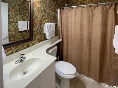 Bathroom featuring walk in shower, vanity, toilet,