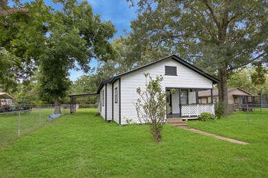 This super charming home sits on a spacious, fenced yard with mature trees.