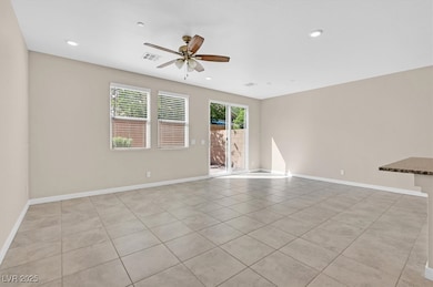 Spare room with plenty of natural light, light tile patterned floors, recessed lighting, and a ceiling fan