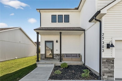 View of exterior entry with a porch, and stone siding