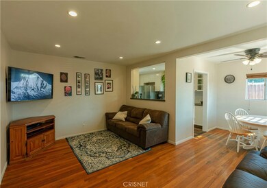 Front room with reccessed lighting and hardwood floors