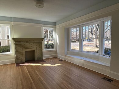 Unfurnished living room with visible vents, basebo