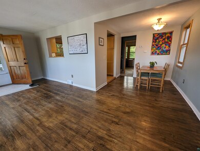 Unfurnished dining area with dark hardwood / wood-