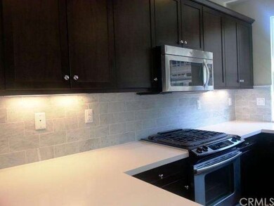Kitchen cabinets are dark maple w stone countertop