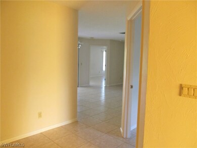 View from foyer looking into a large living area and master bedroom beyond.
