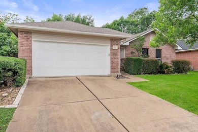 Ranch-style house with brick siding, concrete dri