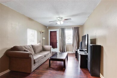 Living room has neutral wall colors and laminate w