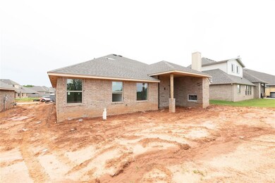 Back of house with brick siding and roof with shin