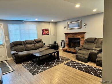 Living room with wood-type flooring and a fireplac