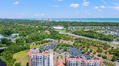 View of urban area with a nearby body of water and a tree filled landscape