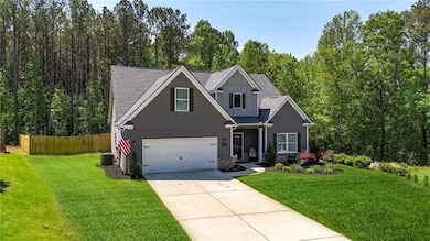 Craftsman-style house featuring fence, a front yar