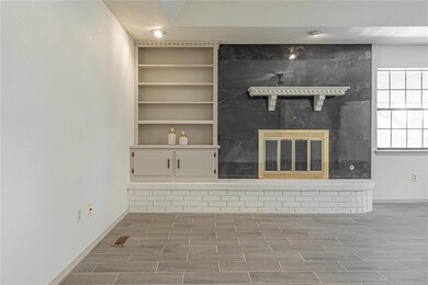 Unfurnished living room featuring baseboards, wood
