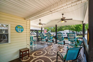 View of patio featuring ceiling fan and a porch