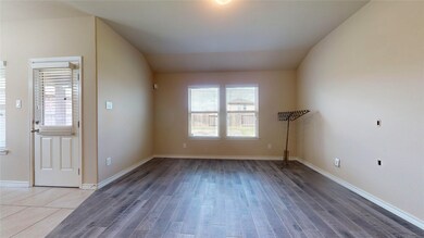 29022 Jacobs River Dr, Katy, TX 77494, Open concept family room with wooden tile flooring and entry to dinning area and kitchen.