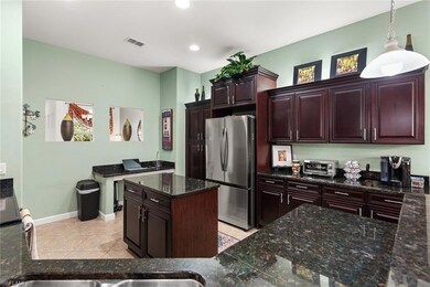 Kitchen with light tile patterned floors, baseboar