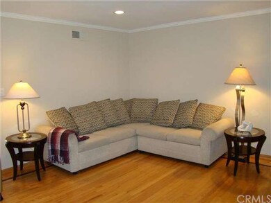 Living room features quality wood flooring, crown 