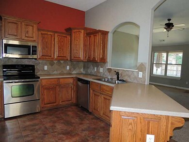 Kitchen. Pretty oak cabinets & tumbled marble back