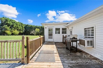 Back deck with ramp on to back yard and in to the with sunroom
