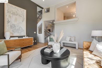 Living room featuring stairway, wood finished floors, and recessed lighting