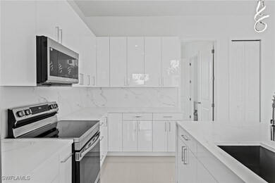 Kitchen featuring stainless steel appliances, whit